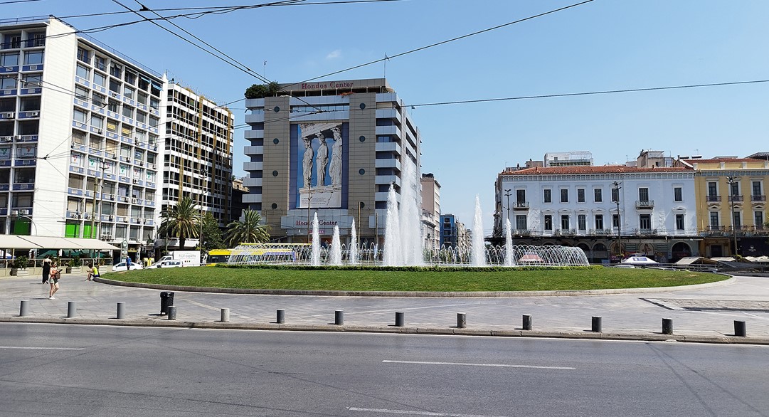 Omonoia Square, almost no people are in the square, and the advertising posters from a commercial center are clearly visible as there is almost no vegetation